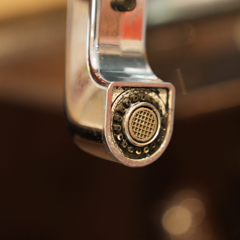 Hard water scale built up on a kitchen faucet aerator