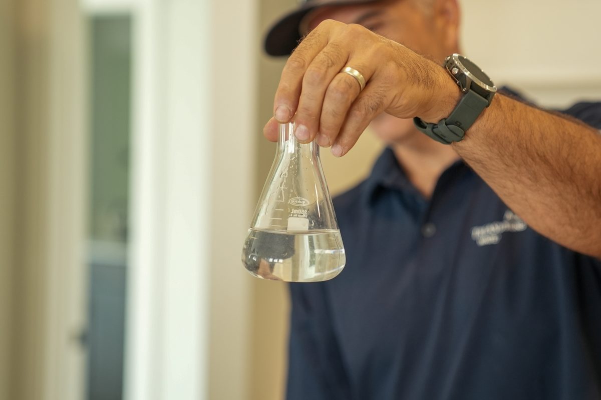 A water sample being checked during a free water test