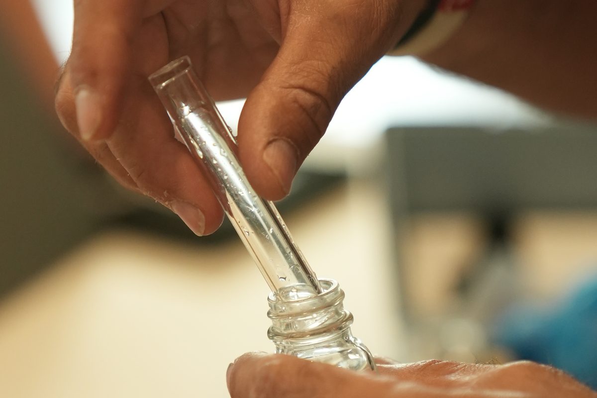 A water sample being drawn for testing at a customer sink
